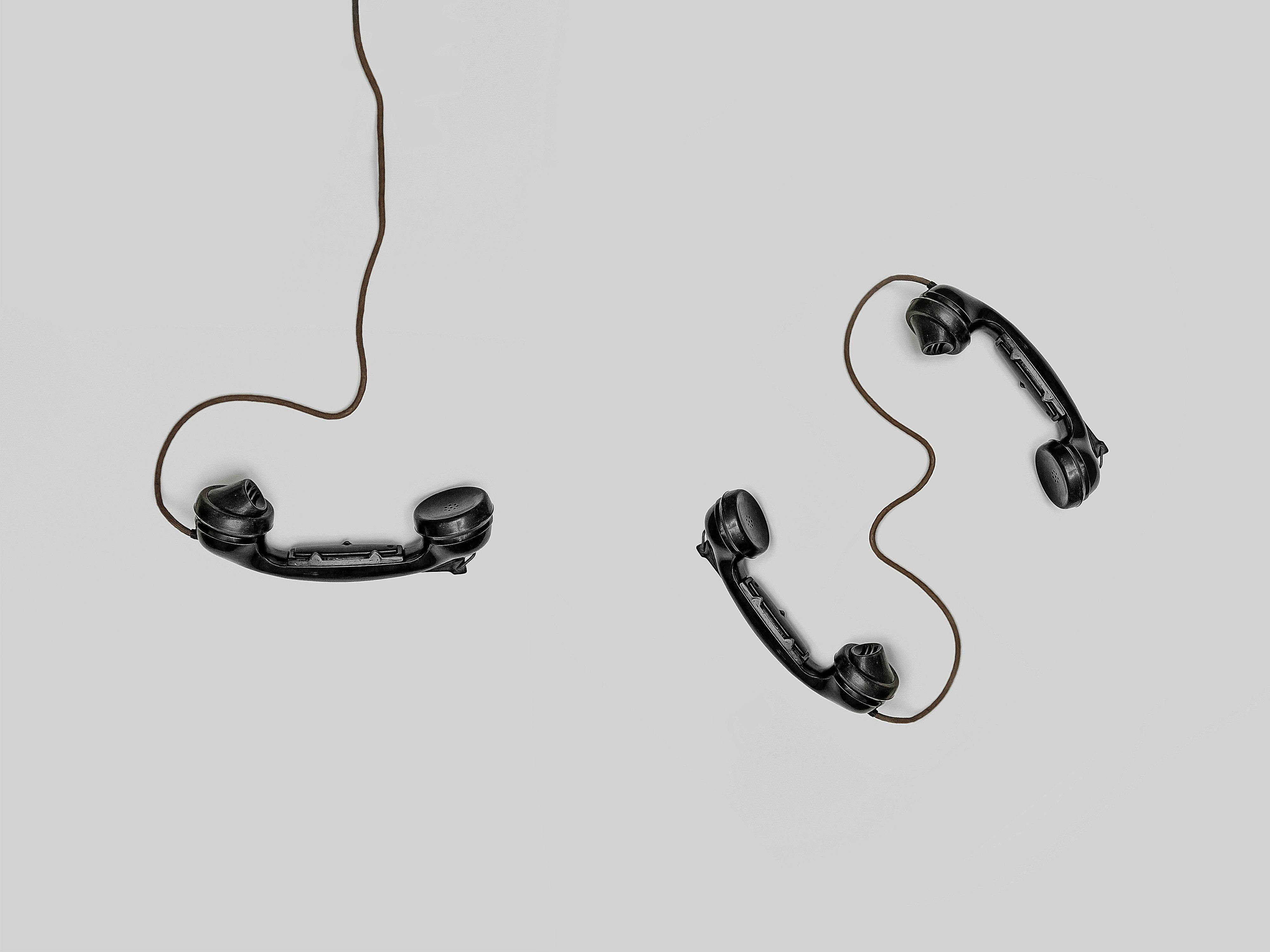 Telephone handsets on a neutral background
